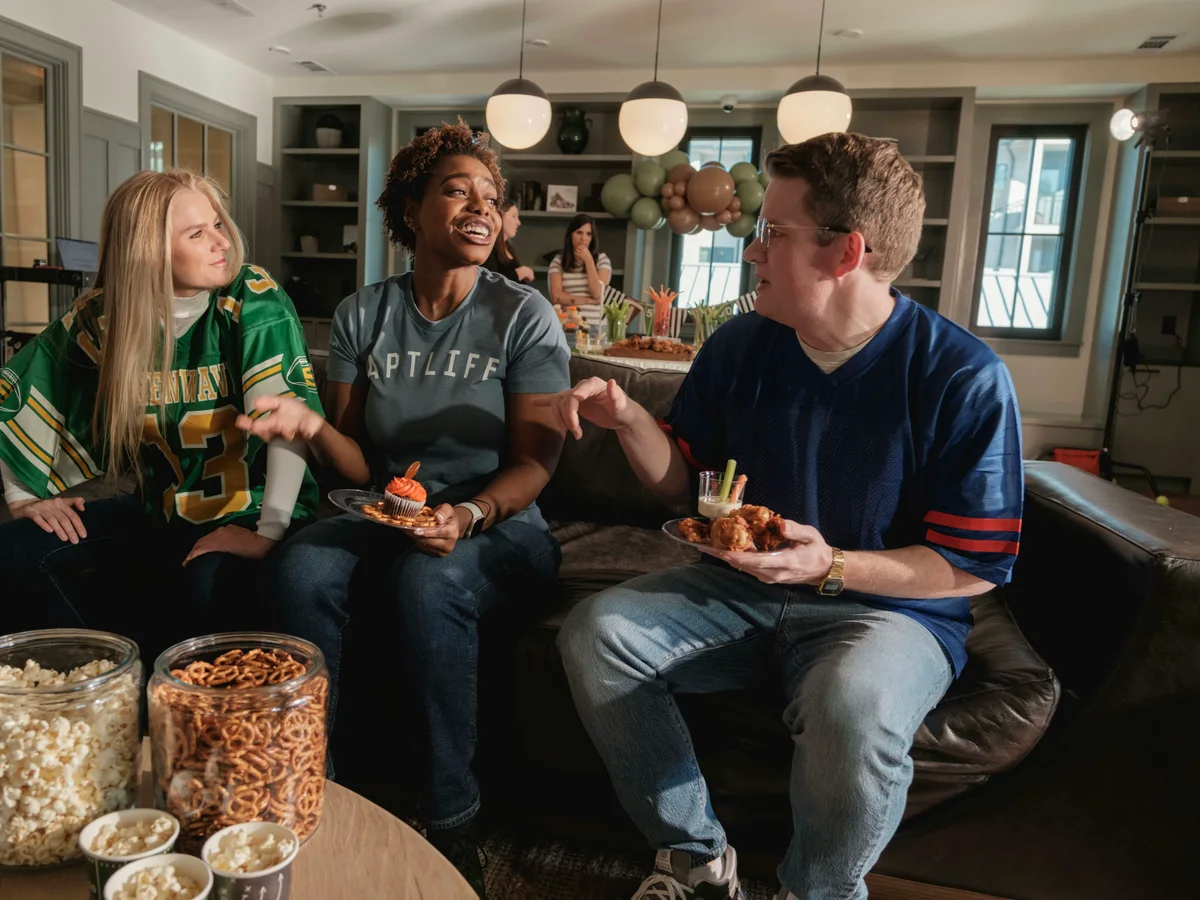 Friends enjoying a live sporting event on television